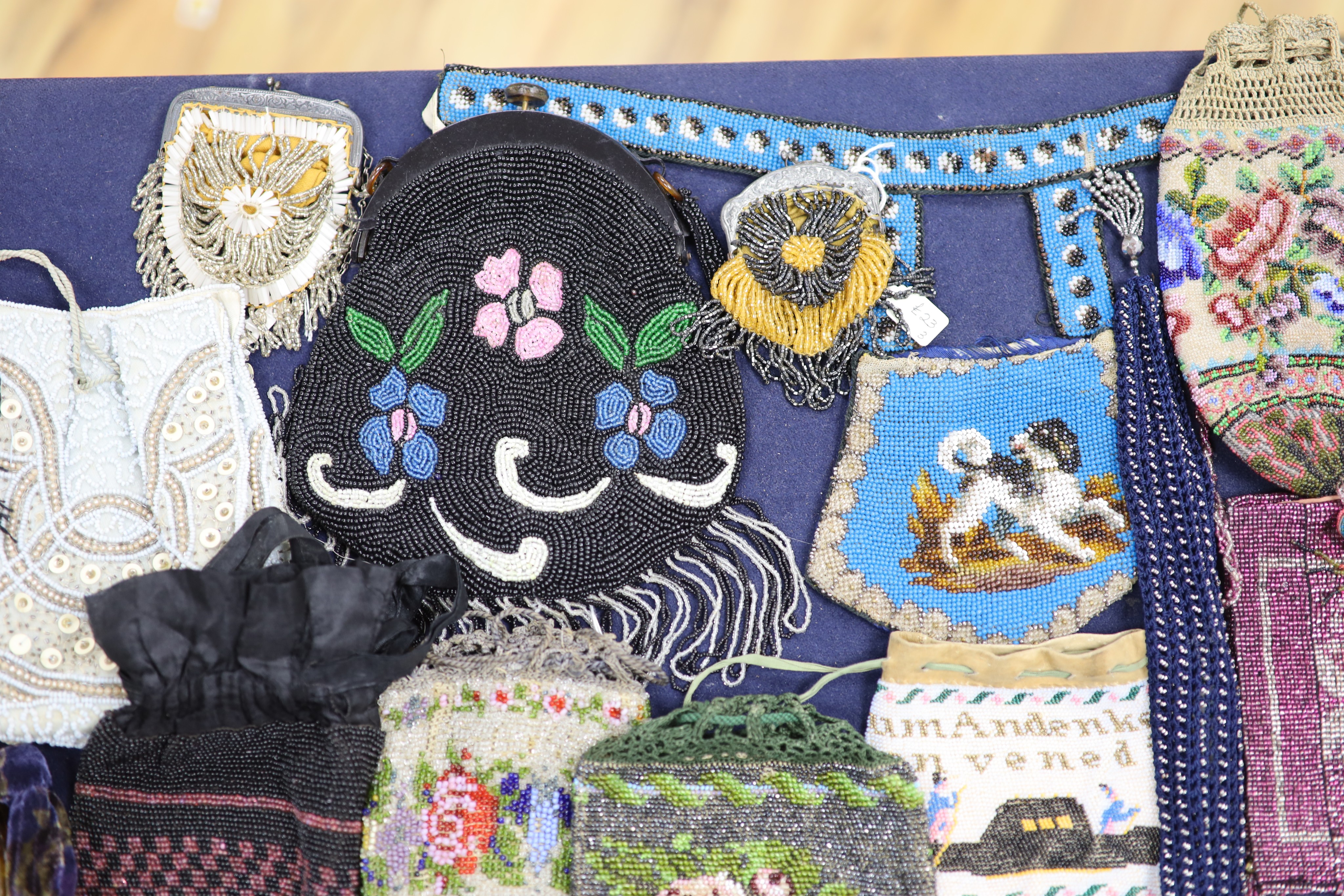 A collection of approximately fifty Victorian and later beadwork, white metal and fabric purses etc.